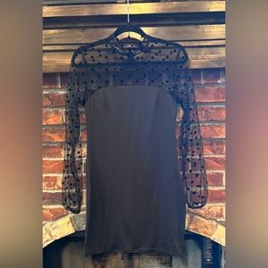 Brand new size medium body con mini dress with sheer arms and neckline